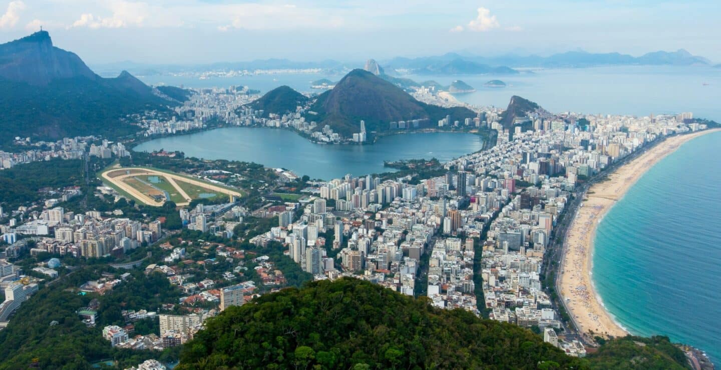 Rio de Janiero, Brazil, taken from the top of the mountain with the city nestled between bodies of water.
